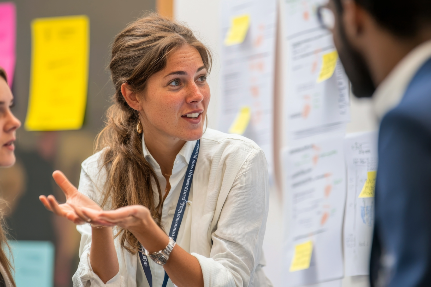 A woman looks at a colleague in work place while speaking