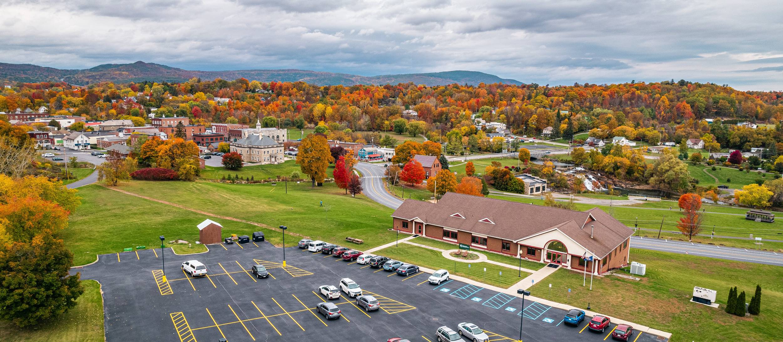 A fall landscape with the college's Ticonderoga campus building set in the foreground
