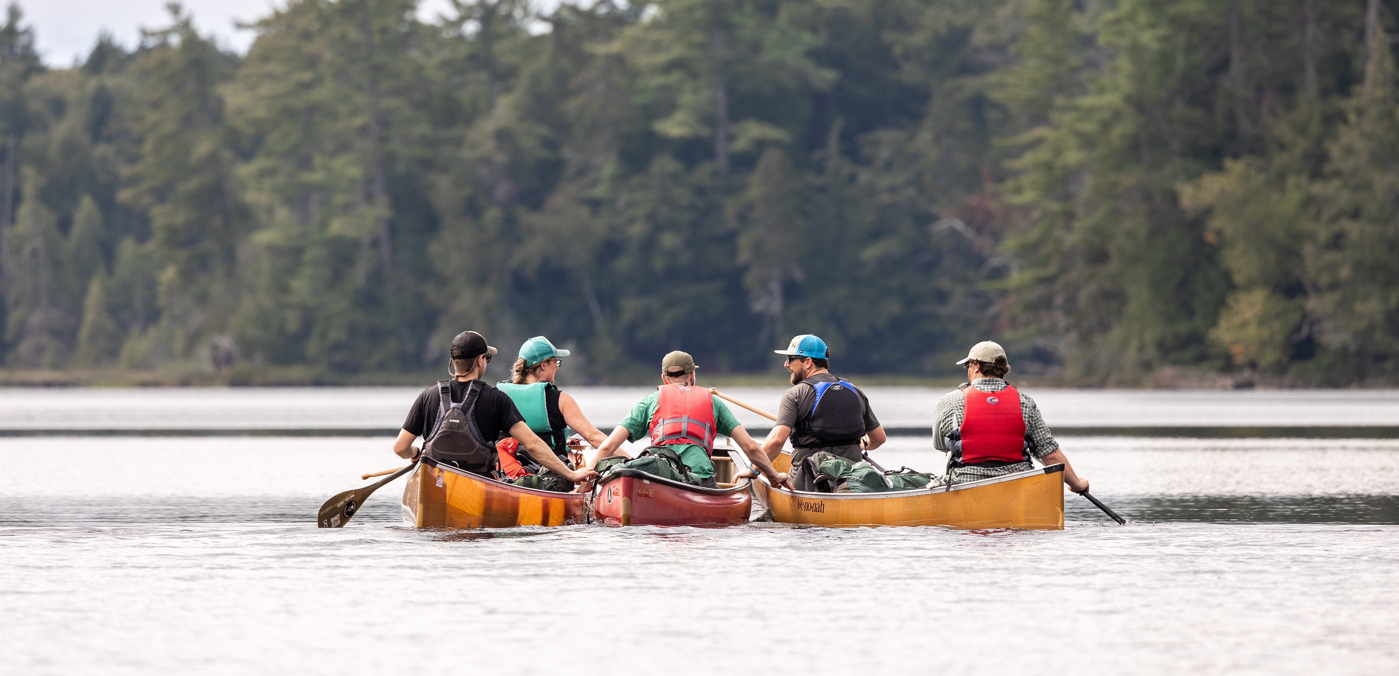 Paddlers in canoes on an Adirondack lake