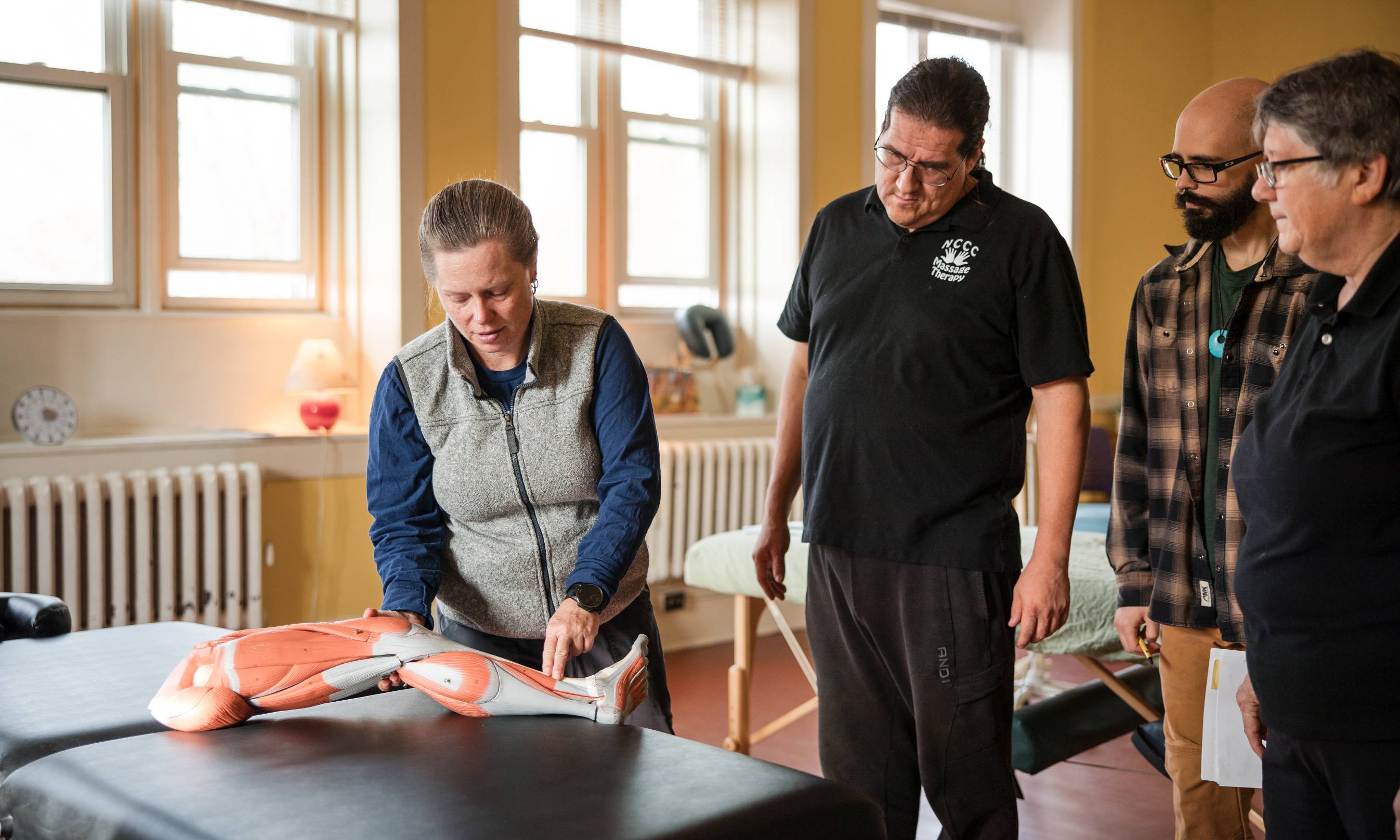 Students in the Massage Therapy program work with an instructor