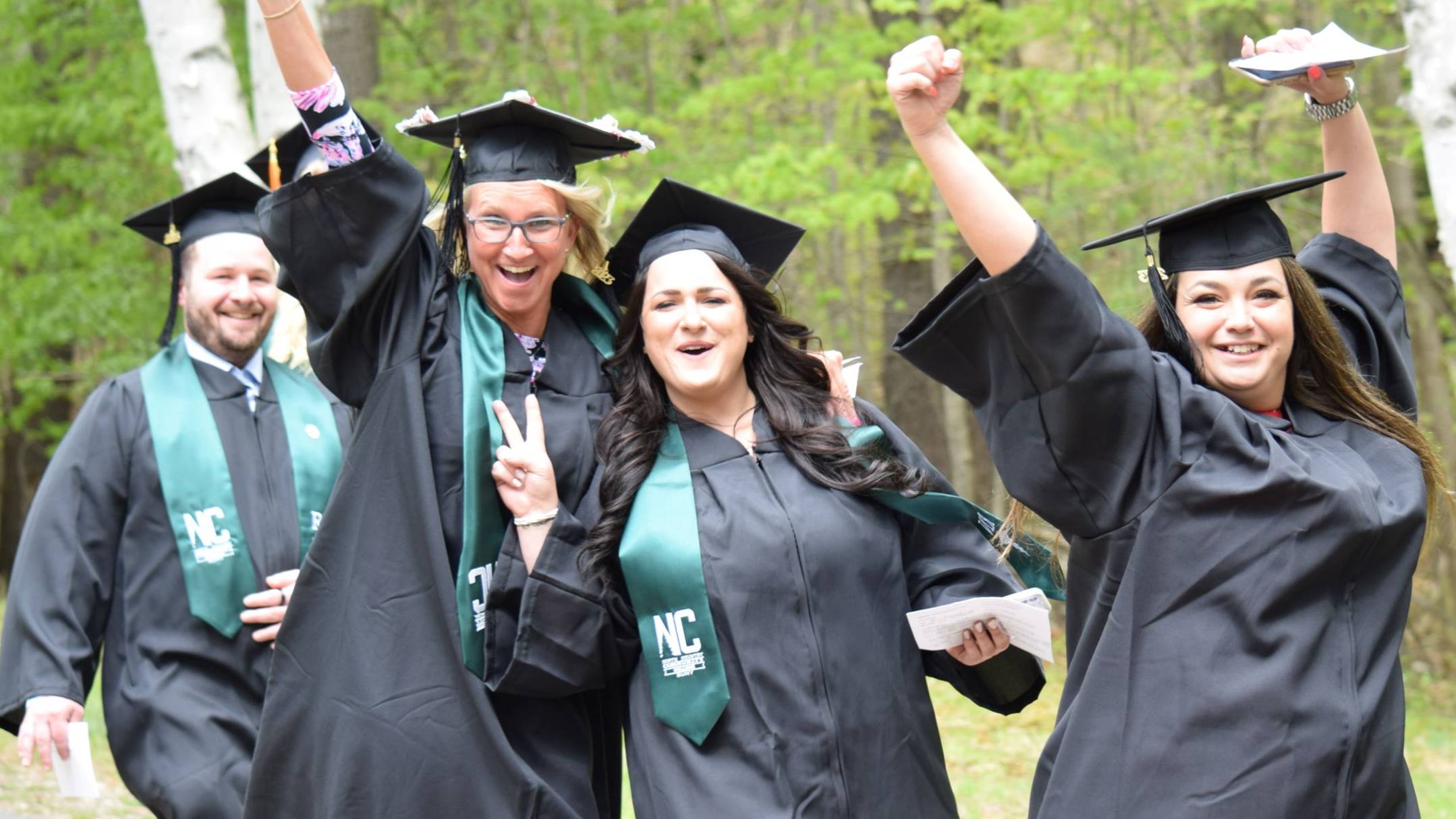 Students celebrate as they walk to Commencement