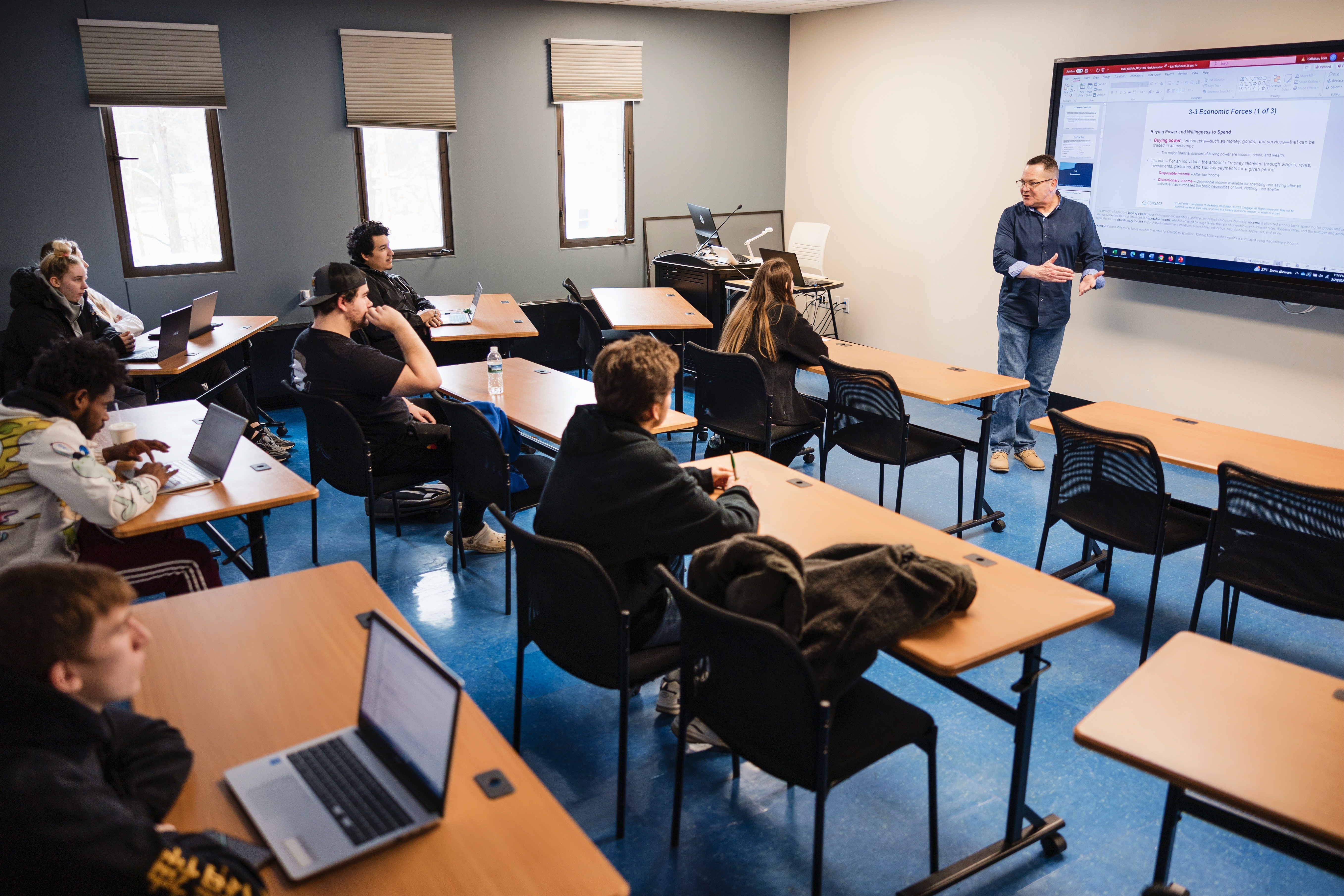Students sit in a classroom listening to an instructor