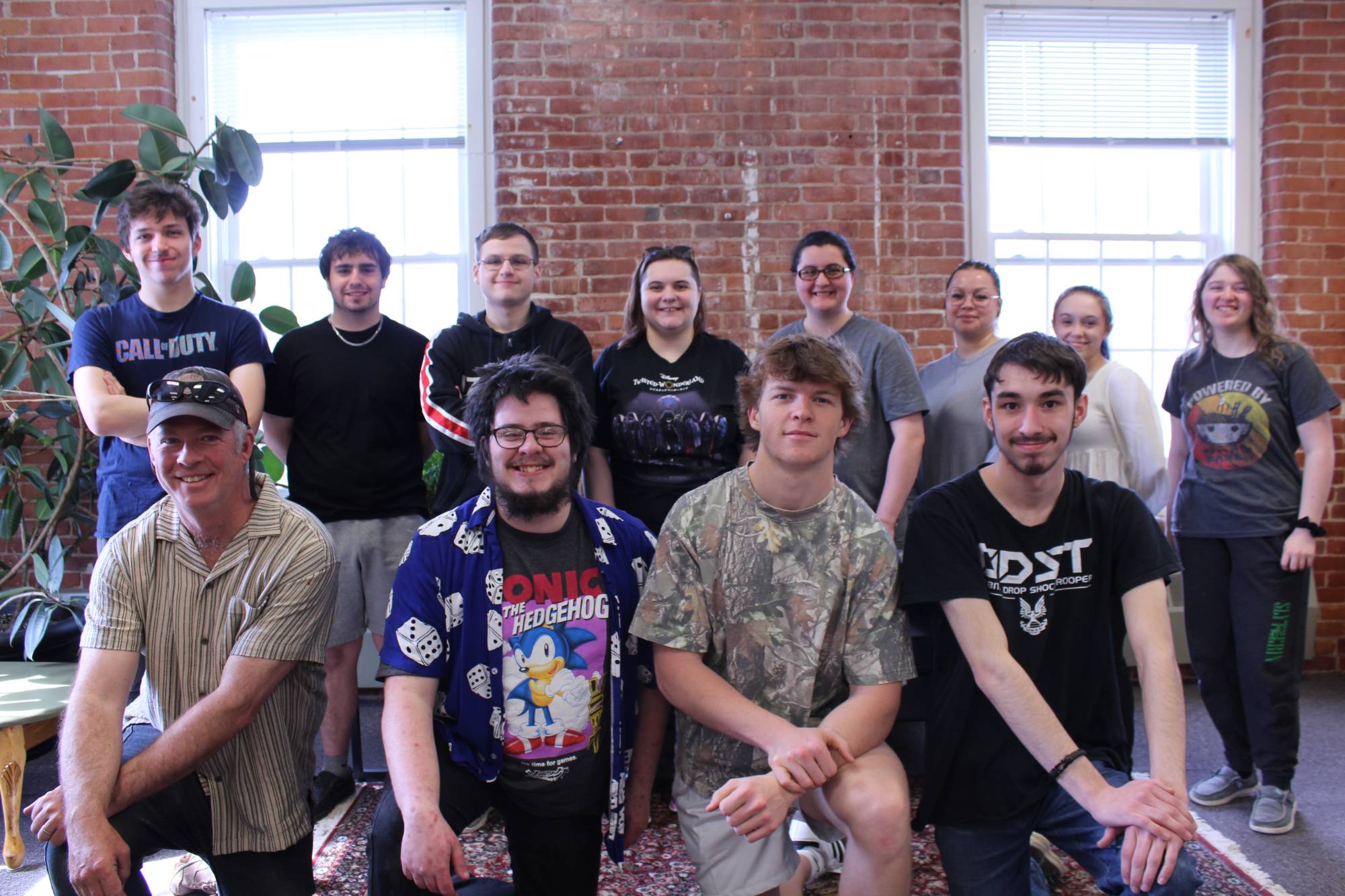 A group of students pose for the camera as a group in a classroom