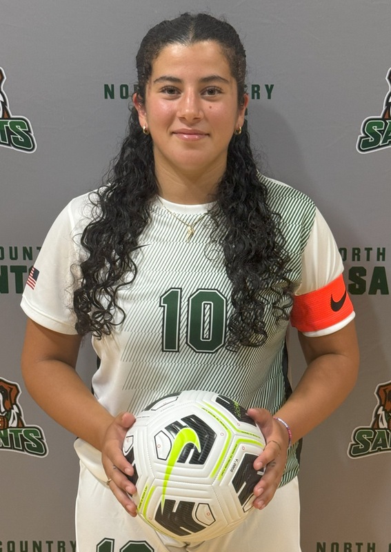 Ella Rejiba, a student and soccer player at NCCC, poses for the camera in uniform holdnig a soccer ball