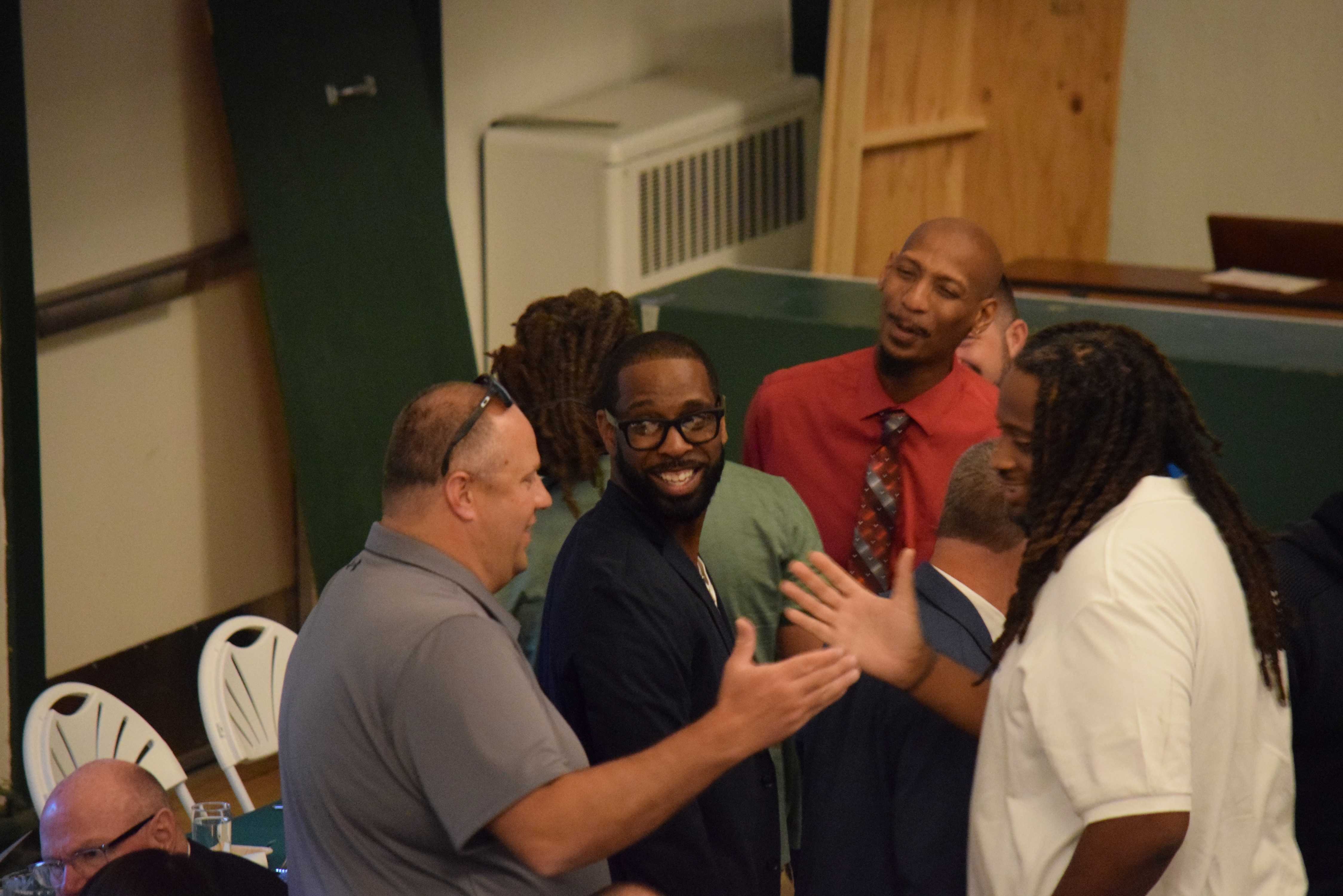 Alumni of the college's athletic program meet during the college's Hall of Fame induction ceremony 