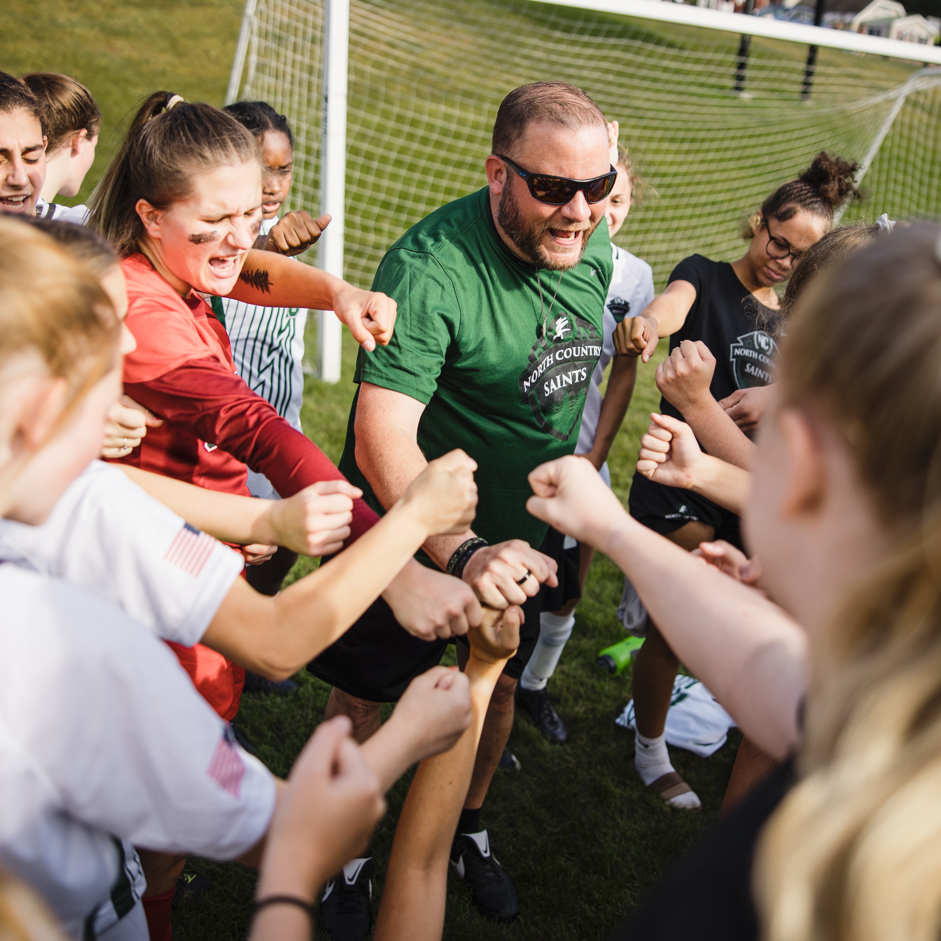 Head Coach Kent Egglefield leads his team in a post-game celebration in the fall of 2022.