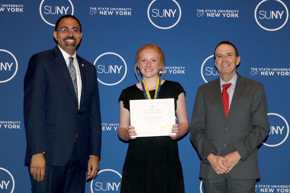North Country Community College sophomore Sydney VanNest, of Lowville, stands with SUNY Chancellor John B. King Jr., left, and college President Joe Keegan after receiving a 2023 SUNY Chancellor's Award for Student Excellence at a ceremony in Albany in April.)