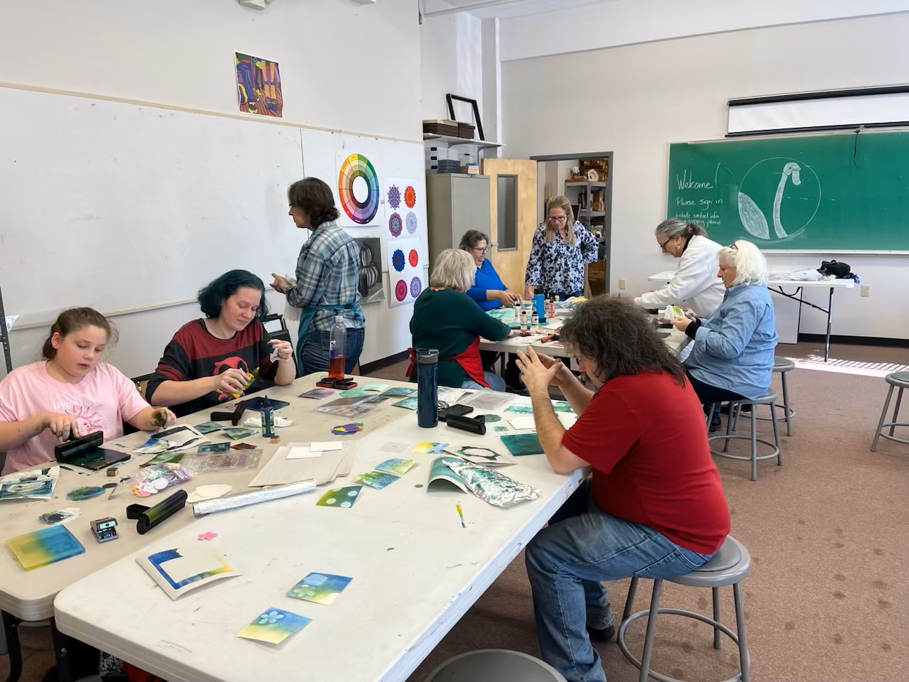 Artists work on prints in a classroom at the college's Malone classroom