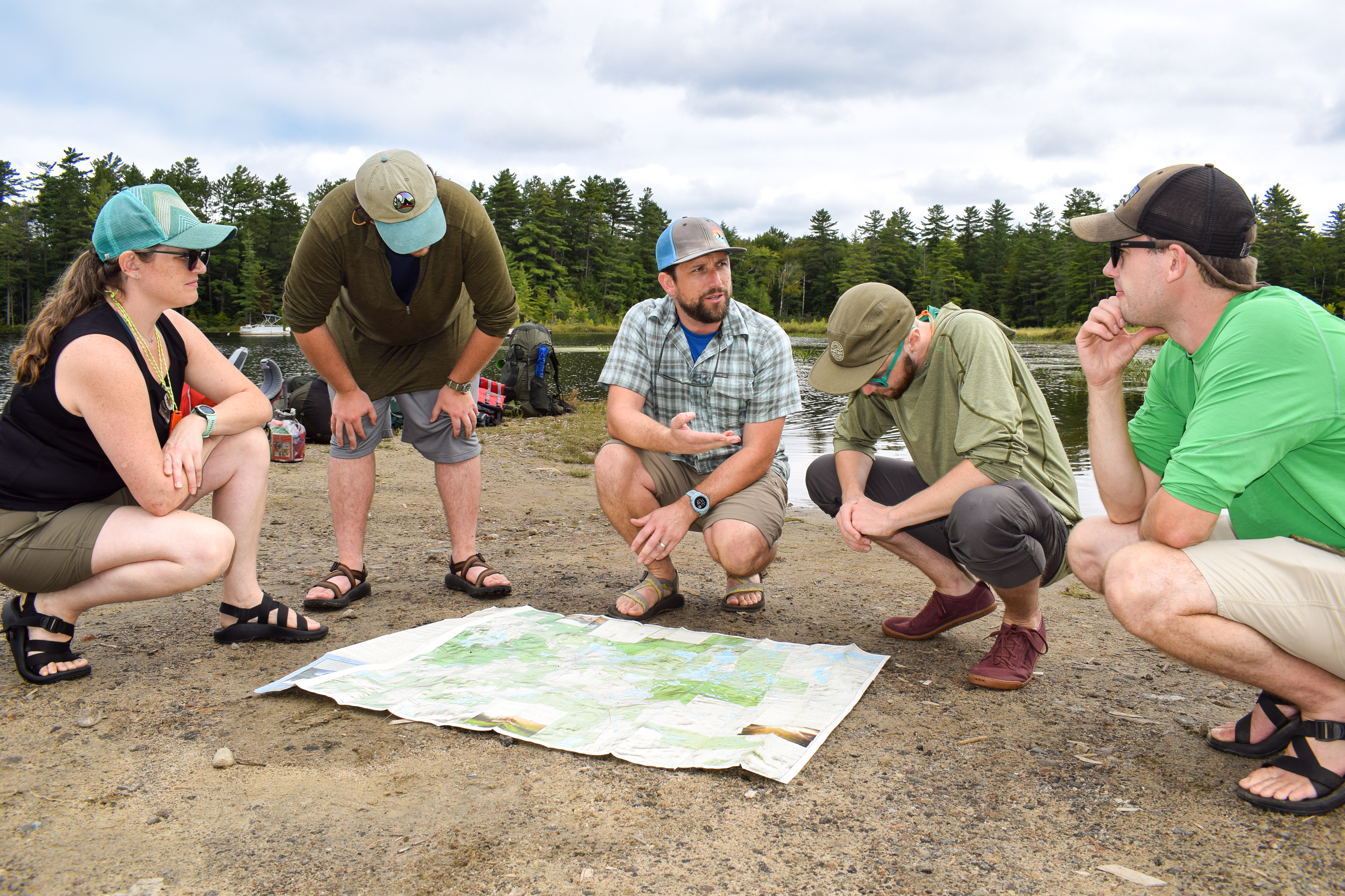 Students talk as they look over a map