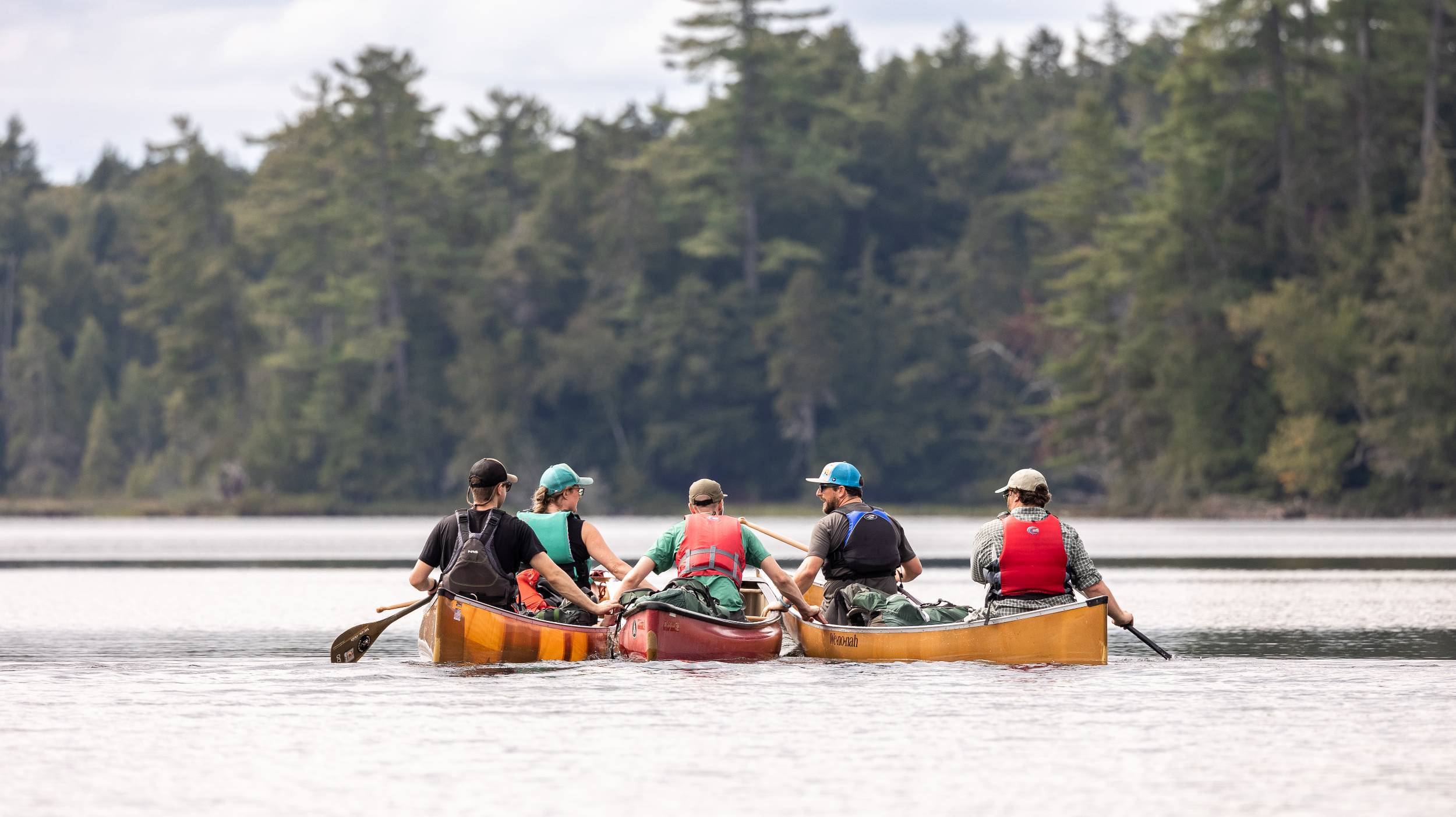 Paddlers in canoes on an Adirondack lake